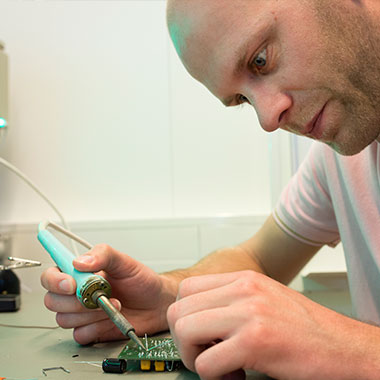 Male student with soldering iron