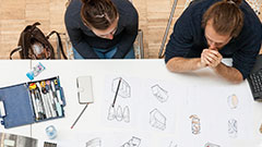 Students sitting at design drawing table