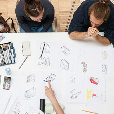 Students sitting at a design drawing table