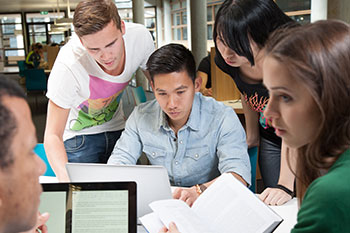 Male and female students helping each other with studies