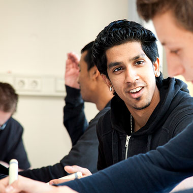 Male student discussing lesson with classmate