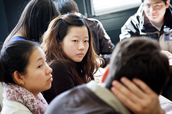 Students in classroom mid discussion